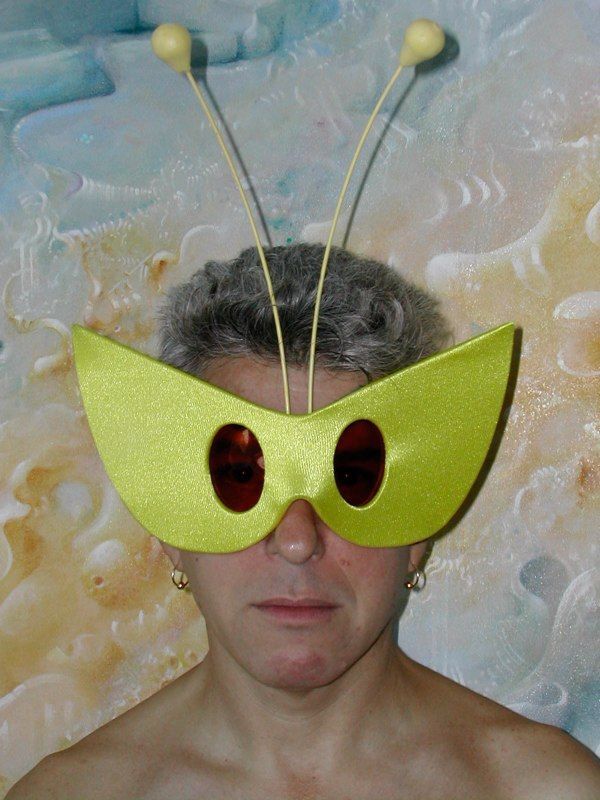 A woman wearing a yellow mask with two holes in it