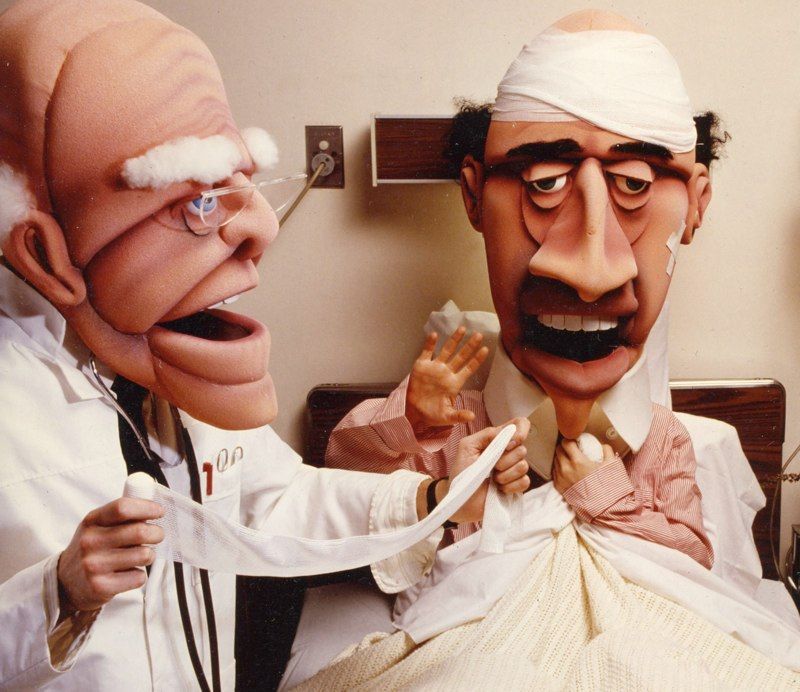 A doctor is examining a patient with a bandage on his head