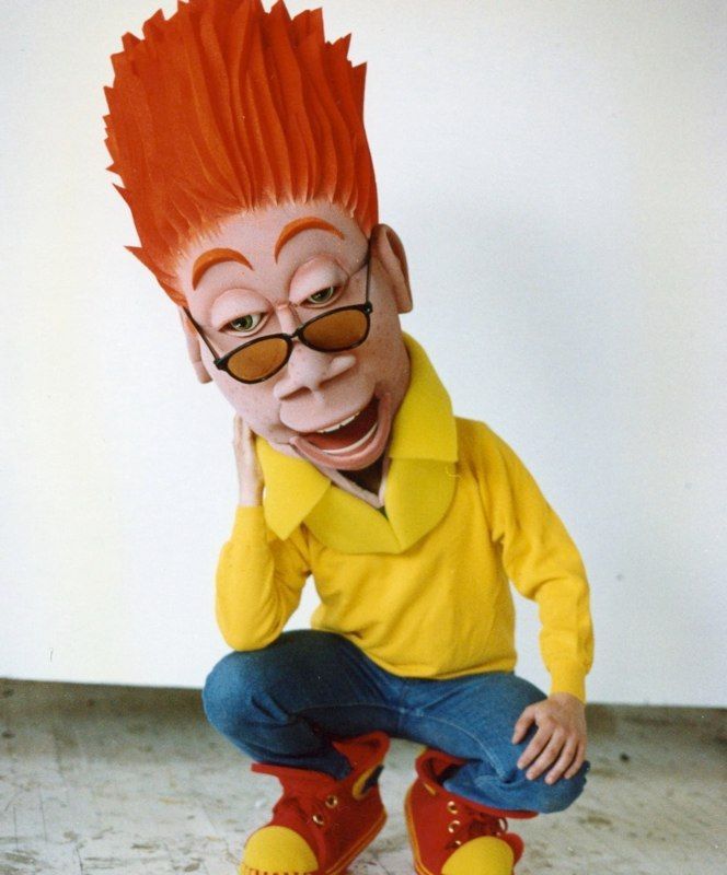 A cartoon character with red hair and sunglasses is squatting down