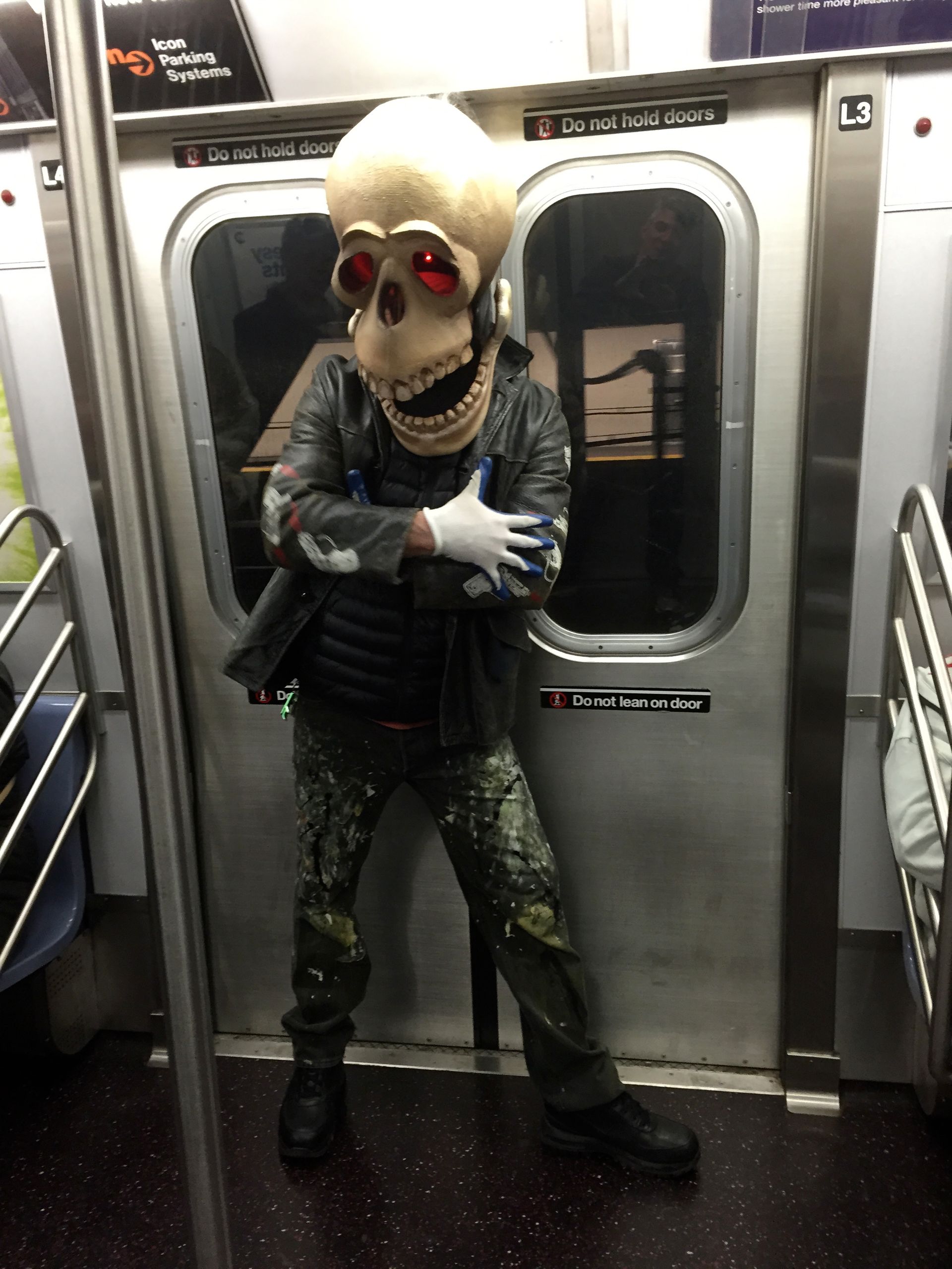 A man in a skeleton costume on a train