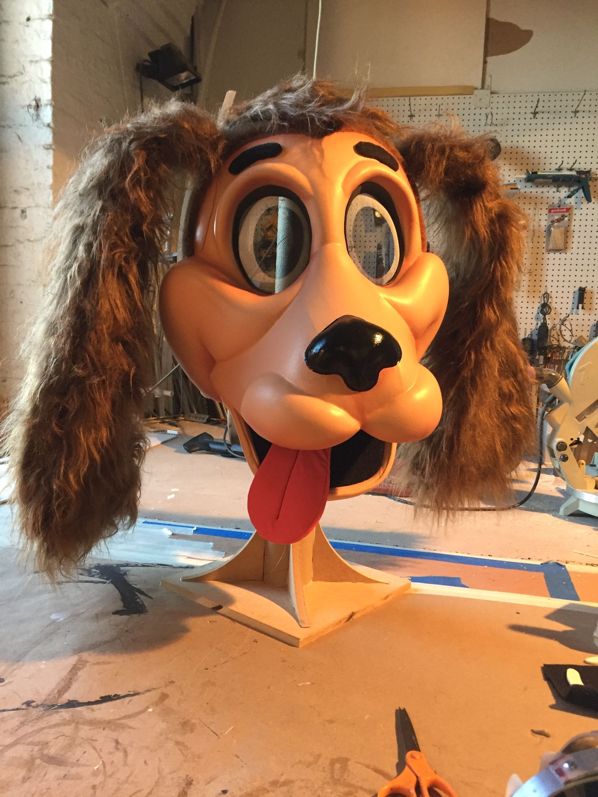 A puppet head of a dog with a red tongue sticking out