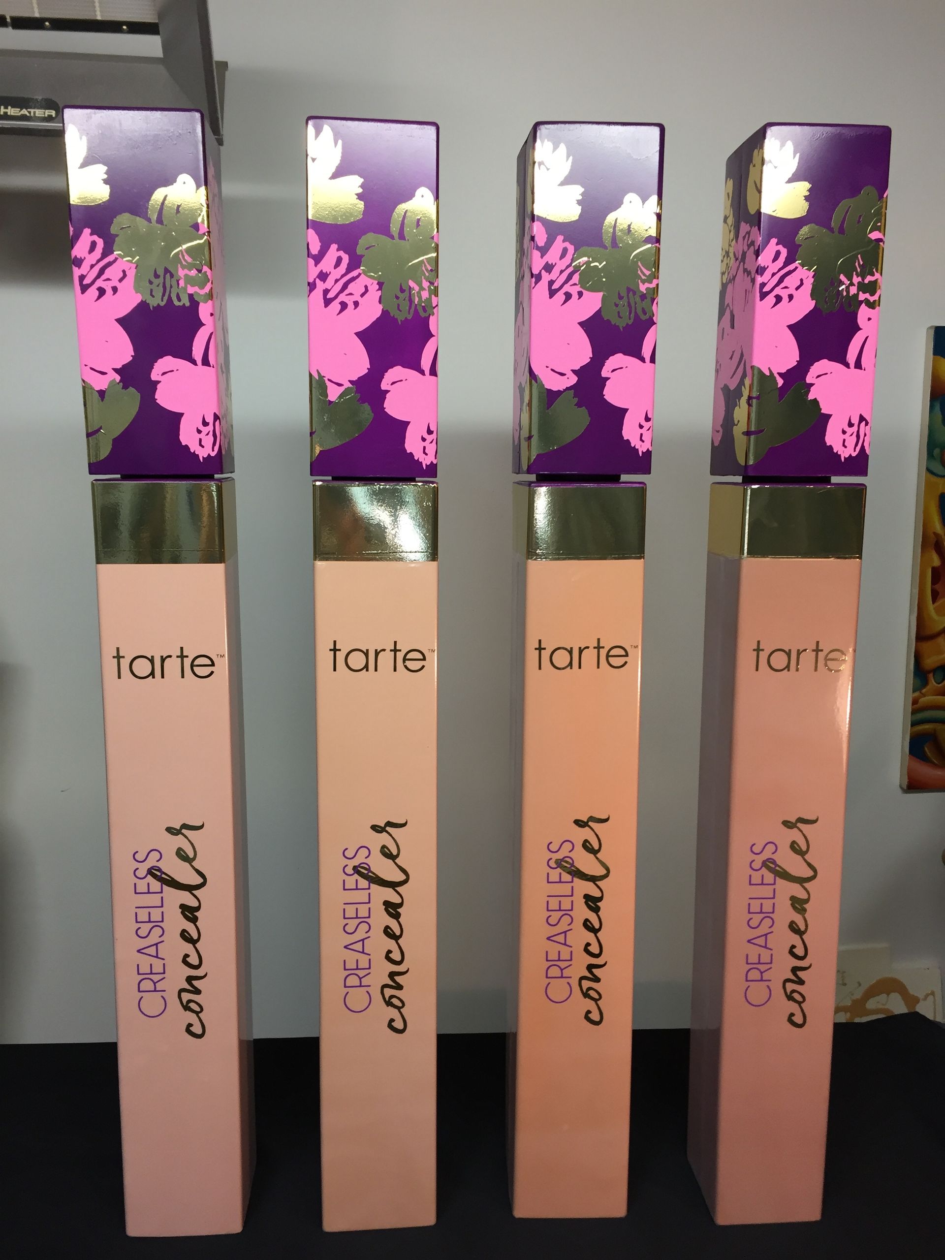 Four bottles of tarte concealer are lined up in a row