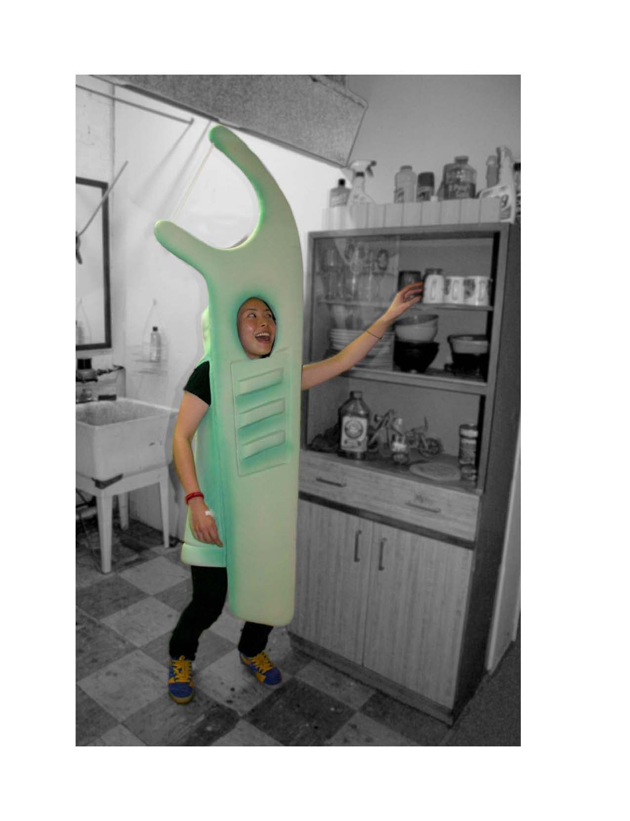 A man in a floss costume is standing in front of a cabinet