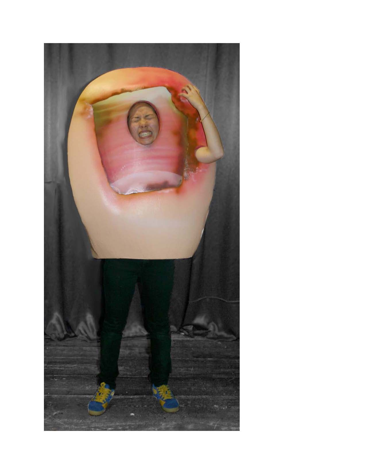 A man is standing in a giant hand costume