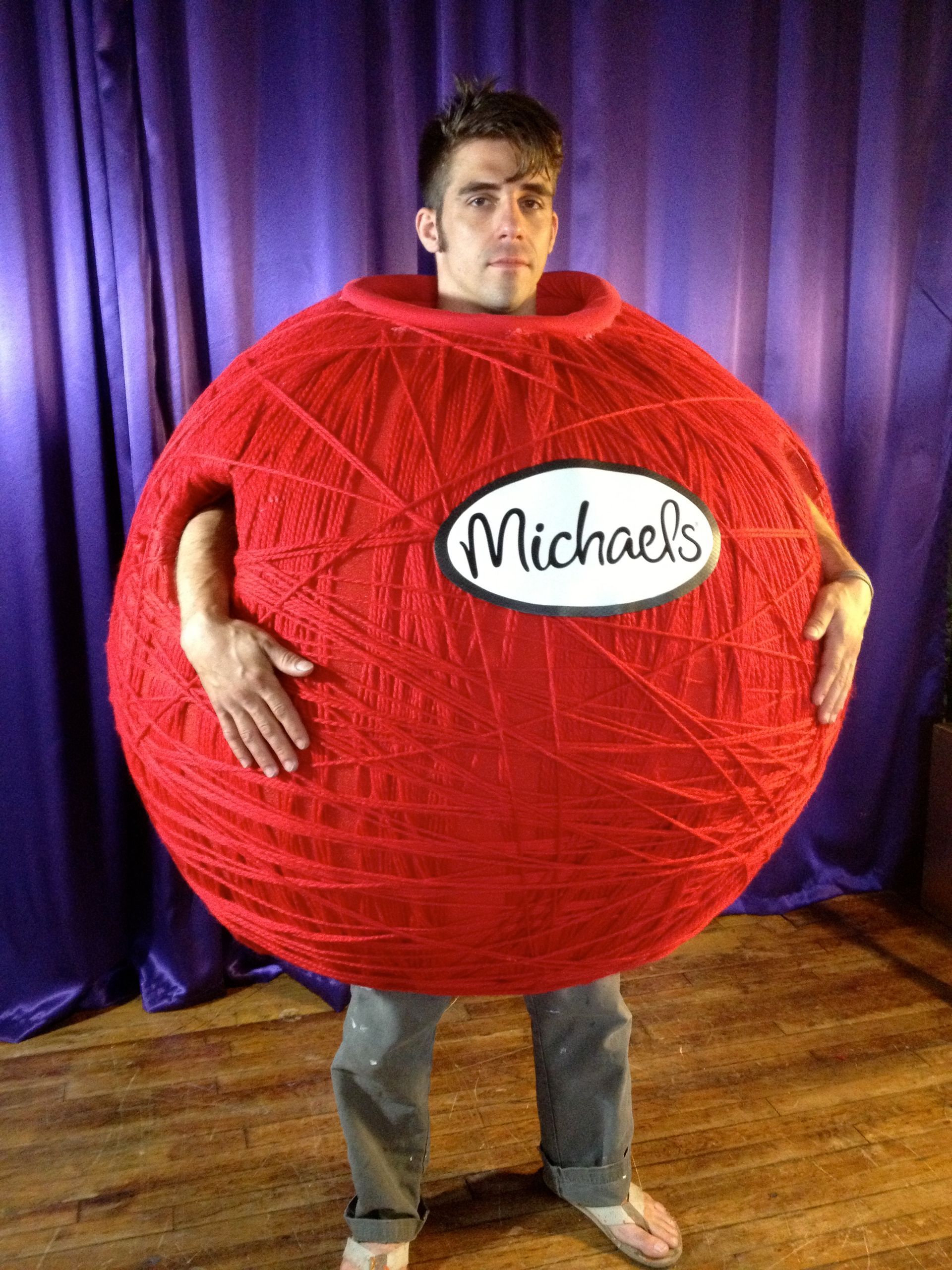 A man is wearing a costume that looks like a ball of yarn.