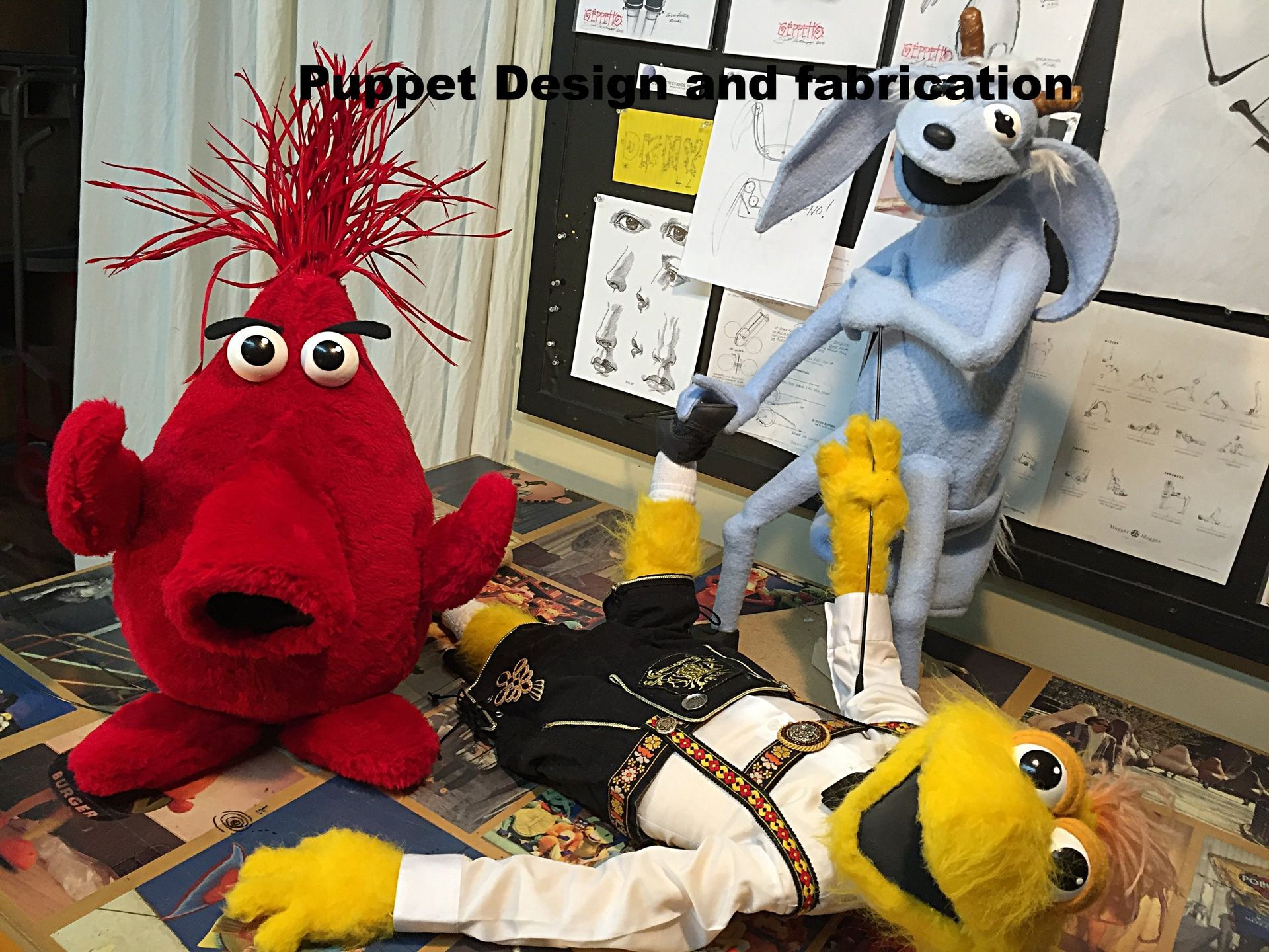 Three stuffed animals are sitting on a table with the words puppet design and fabrication above them