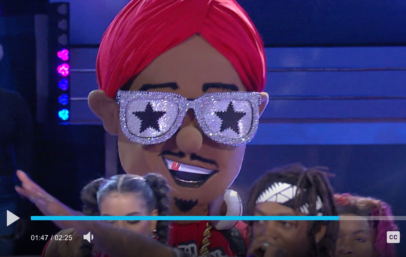 A cartoon character wearing sunglasses and a red turban