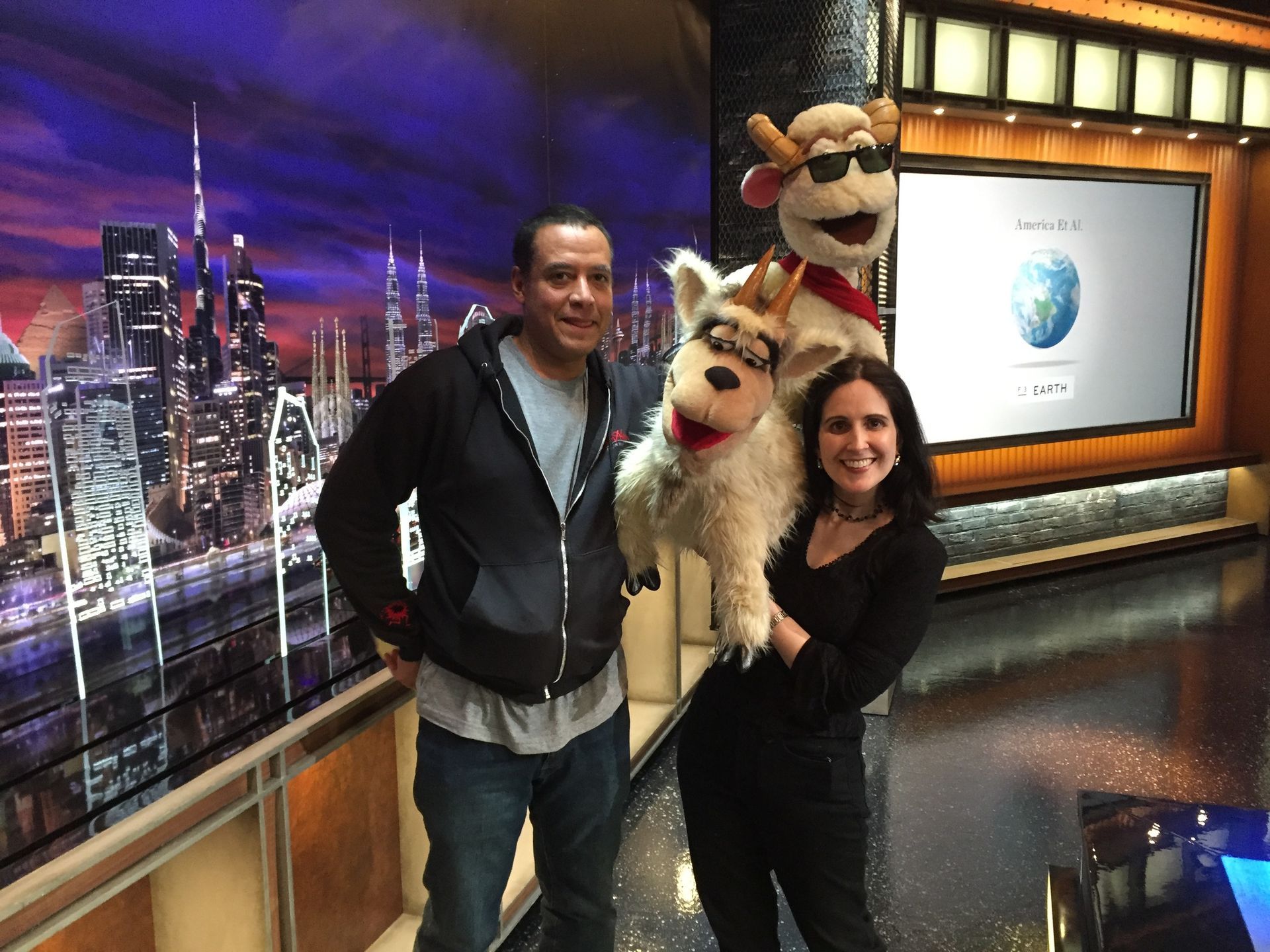 A man and a woman are posing for a picture with stuffed animals