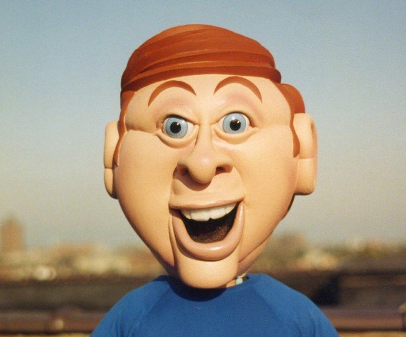 A cartoon character wearing a blue shirt is smiling