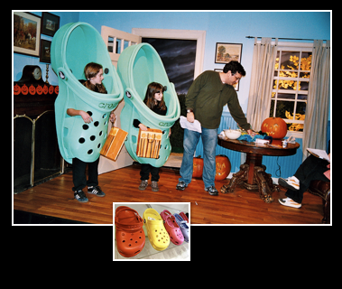 A man and two children dressed as crocs in a living room