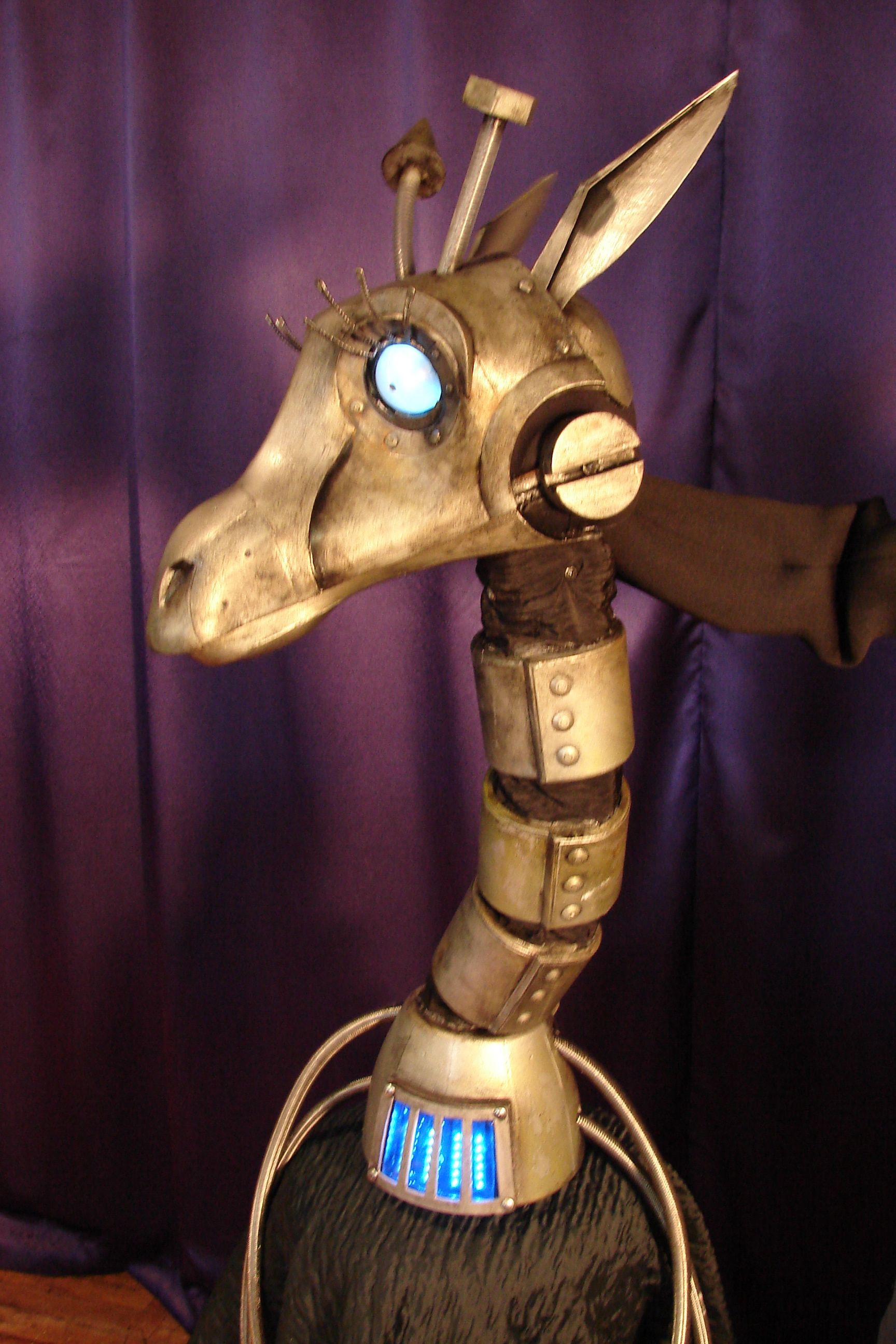 A statue of a giraffe with a purple curtain behind it