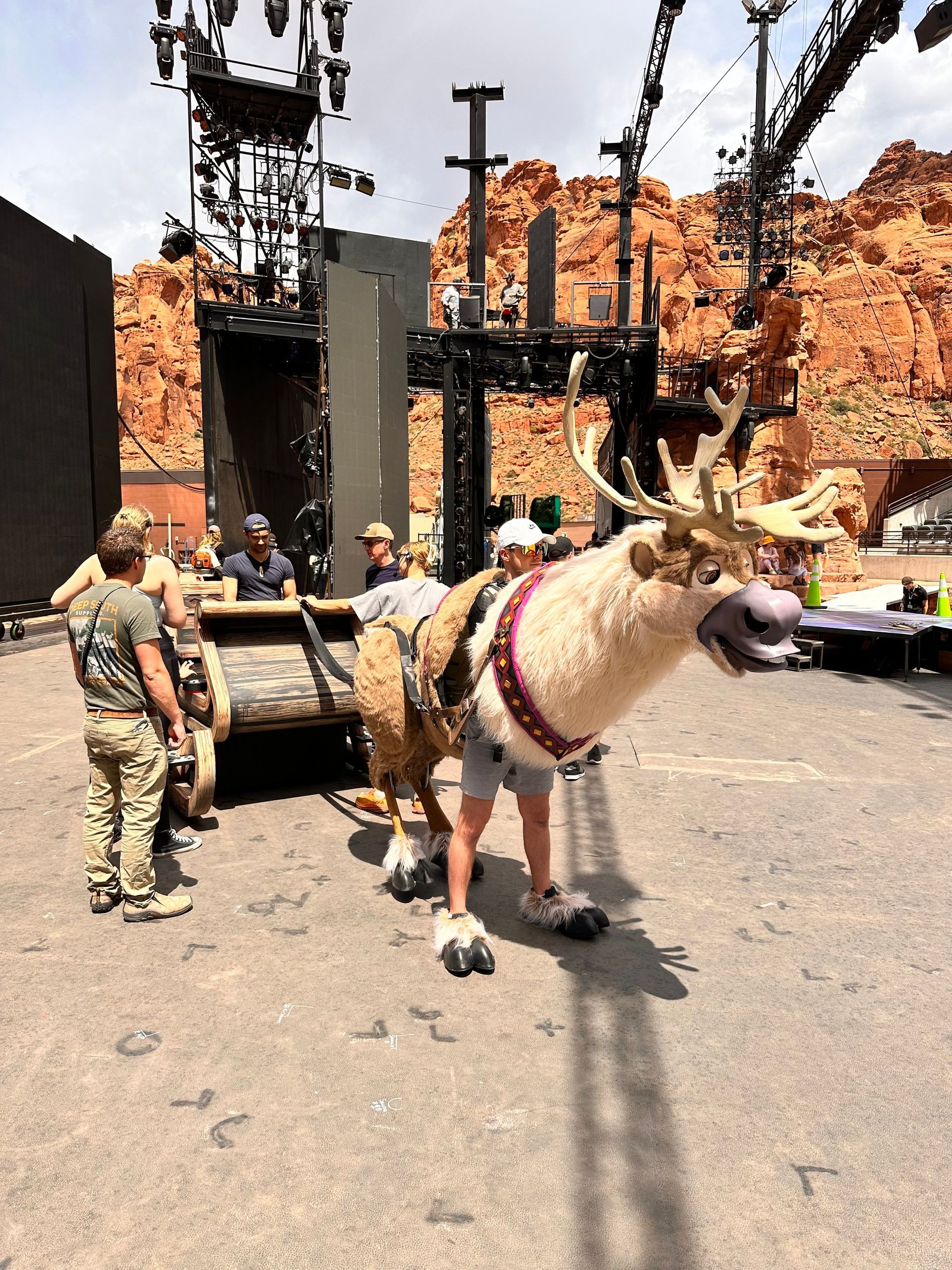 A man in a reindeer costume is standing in front of a group of people