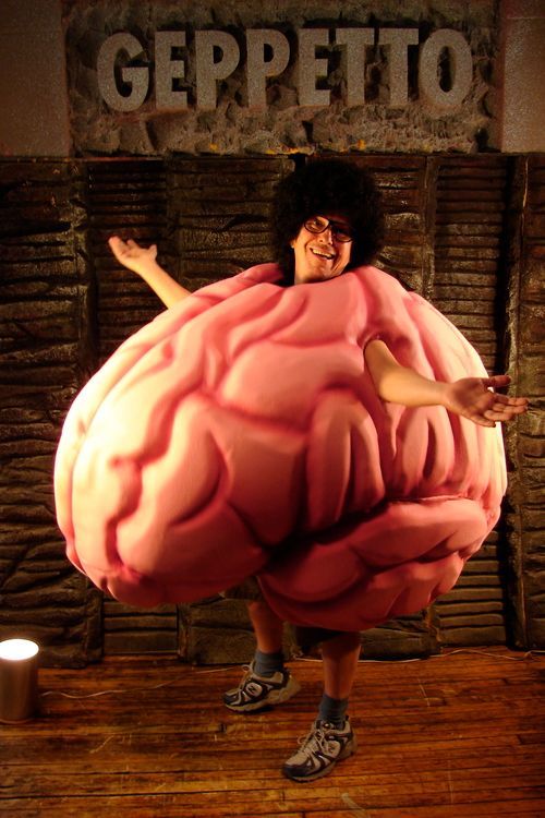 A man in a pink brain costume is standing in front of a sign that says geppetto