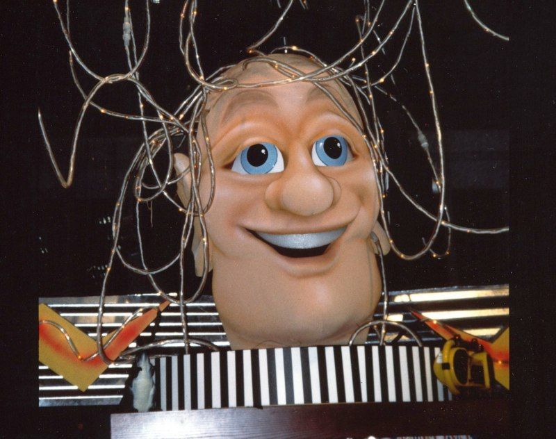 A cartoon head with wires coming out of it is smiling