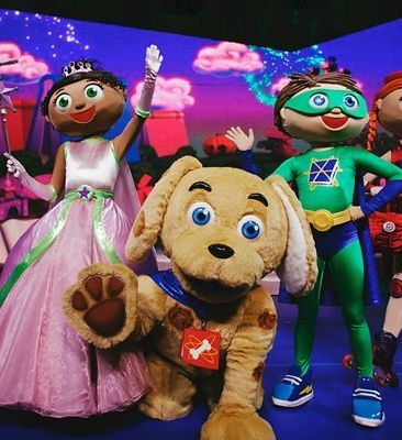 A group of stuffed animals are standing next to each other on a stage.