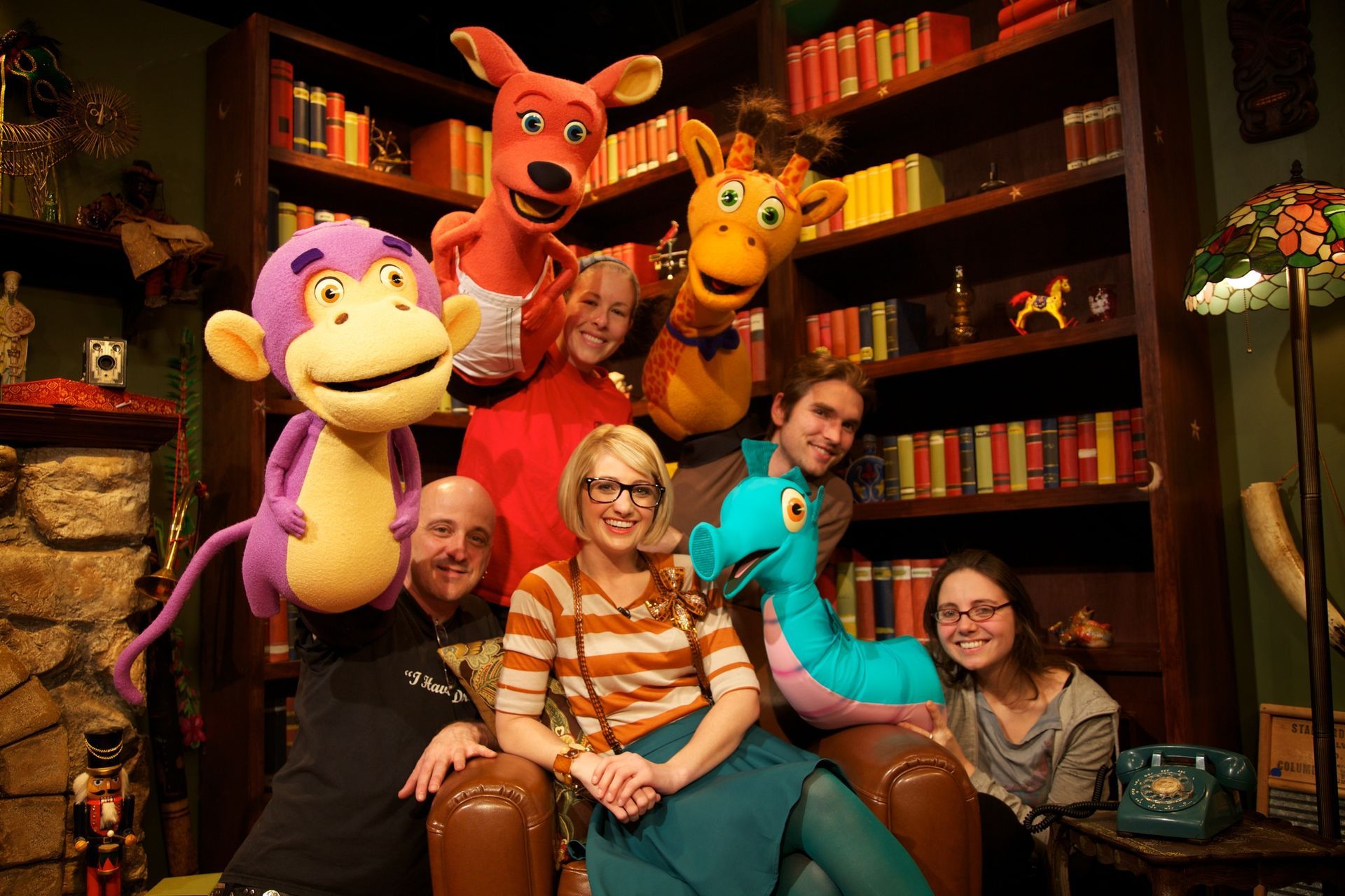 A group of people are posing for a picture with stuffed animals.
