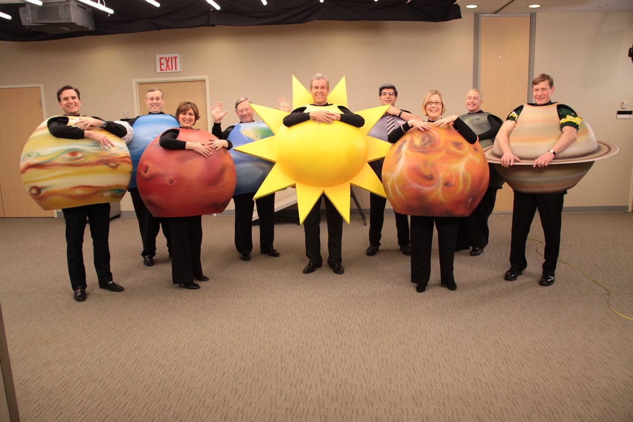 A group of people dressed as planets and the sun