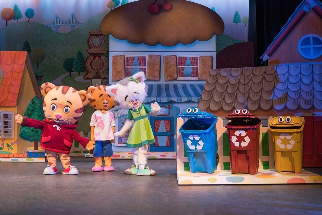 A group of stuffed animals are standing next to each other on a stage.