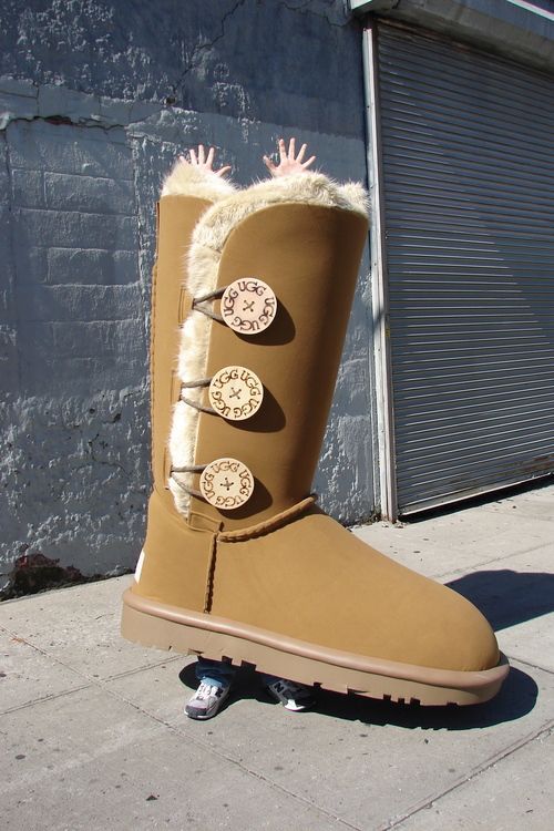 A pair of ugg boots with three buttons on the side