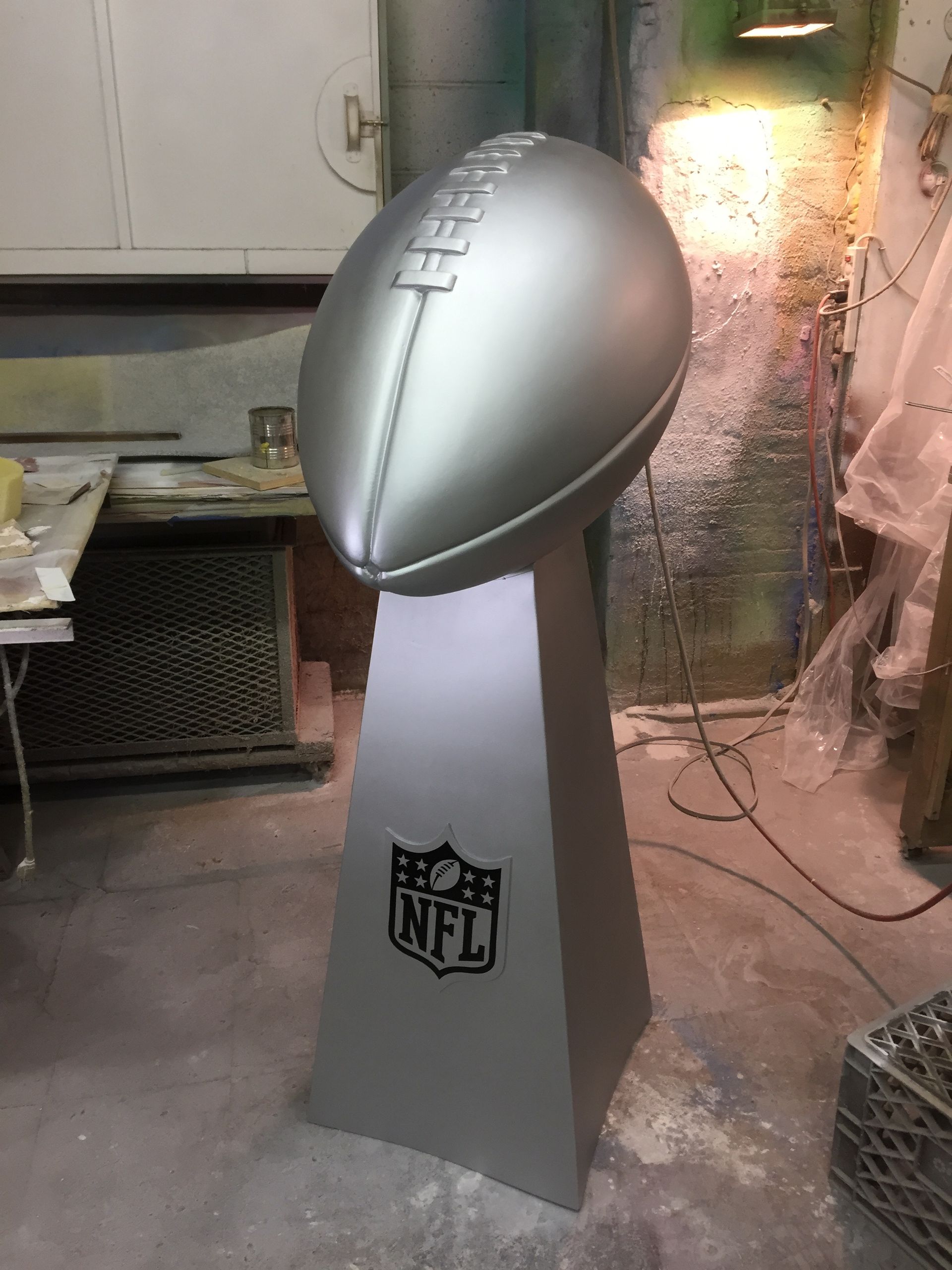 A statue of a football with the nfl logo on it