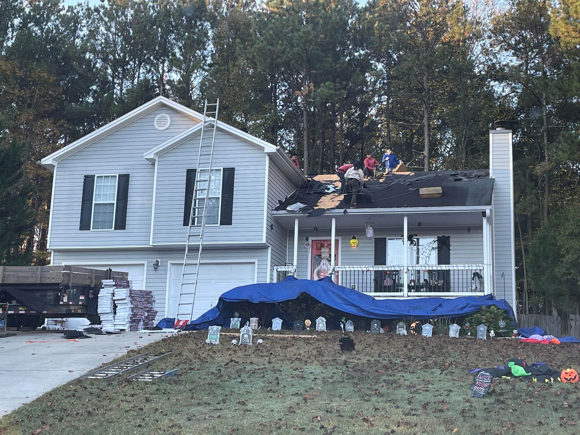 A house is being remodeled with a roof being installed.