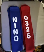 A pair of blue and red headbands with numbers on them are sitting on top of a white table.