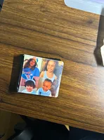 A picture of a family is on a wooden table.