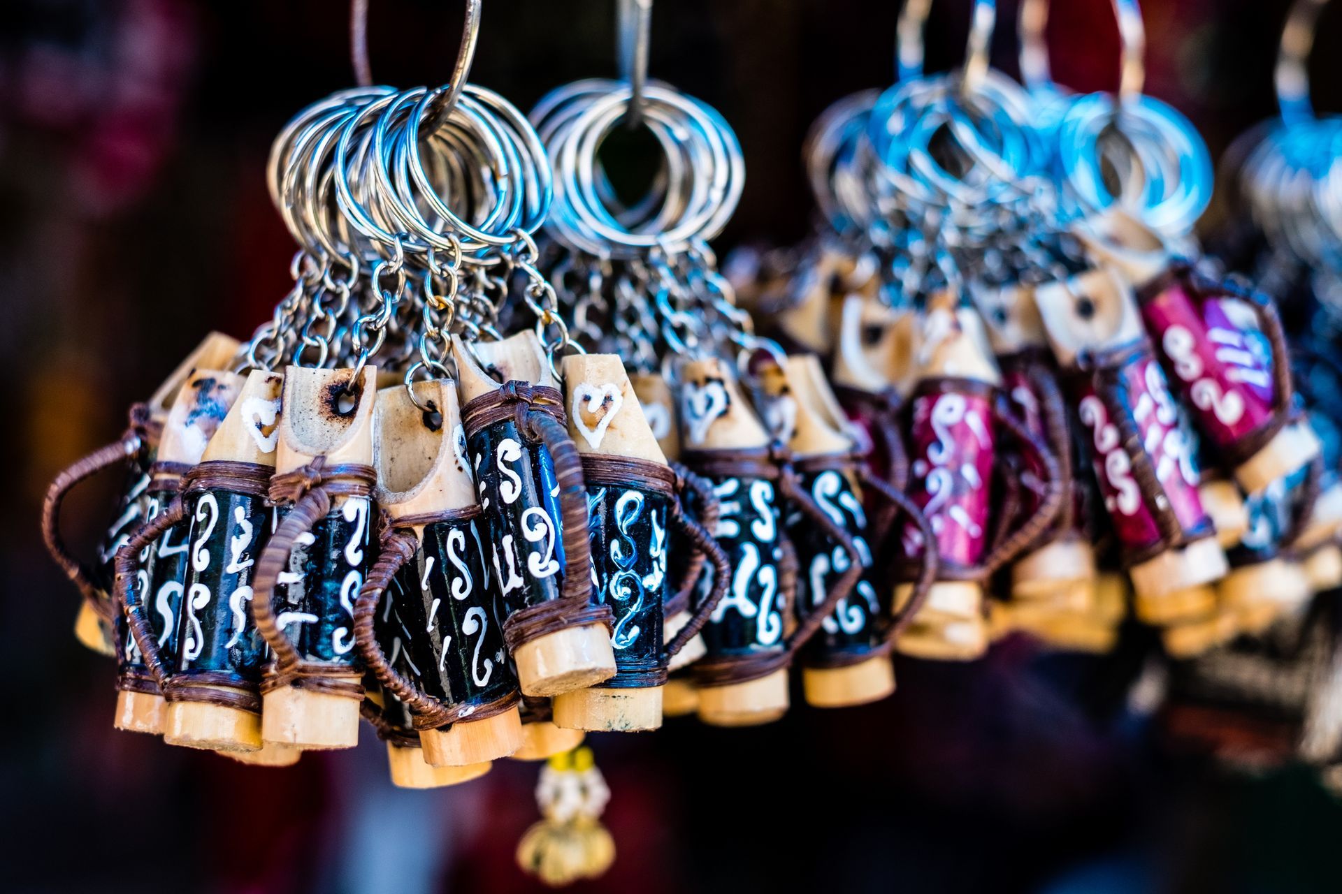 A bunch of key chains hanging from a string.