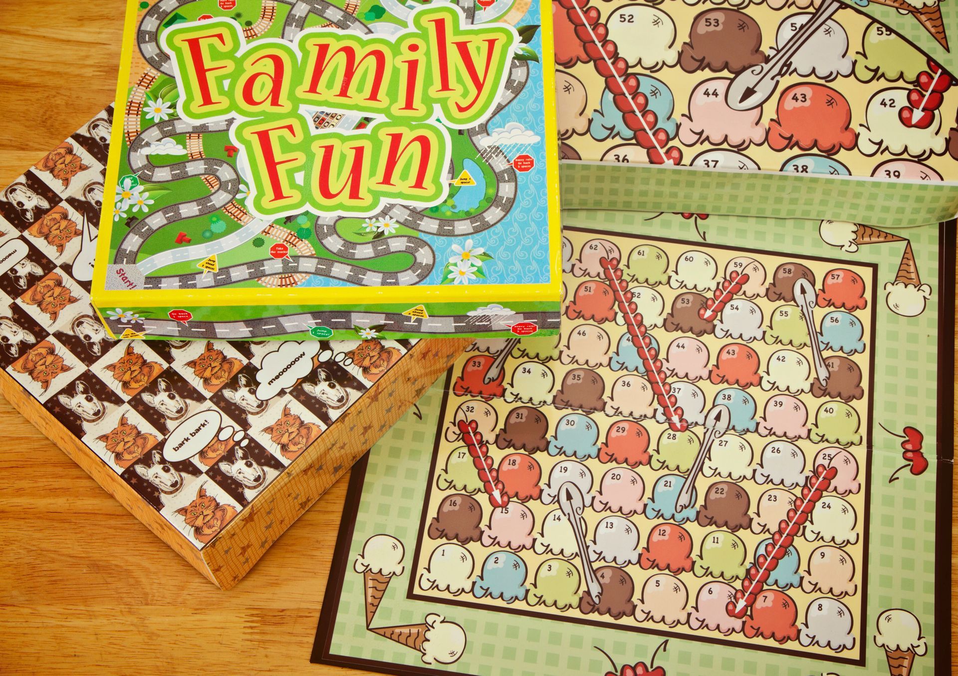 A family fun board game sits on a wooden table