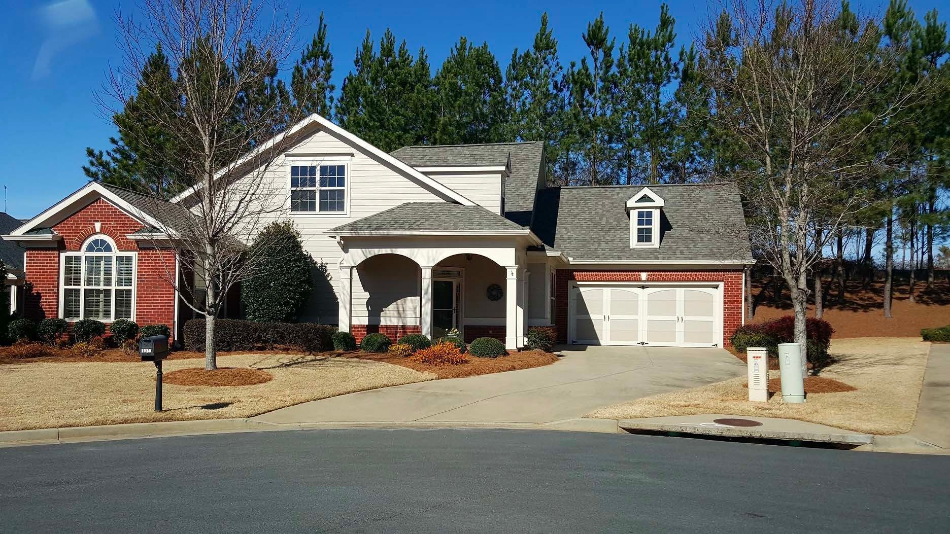 A large red and white house with a gray roof