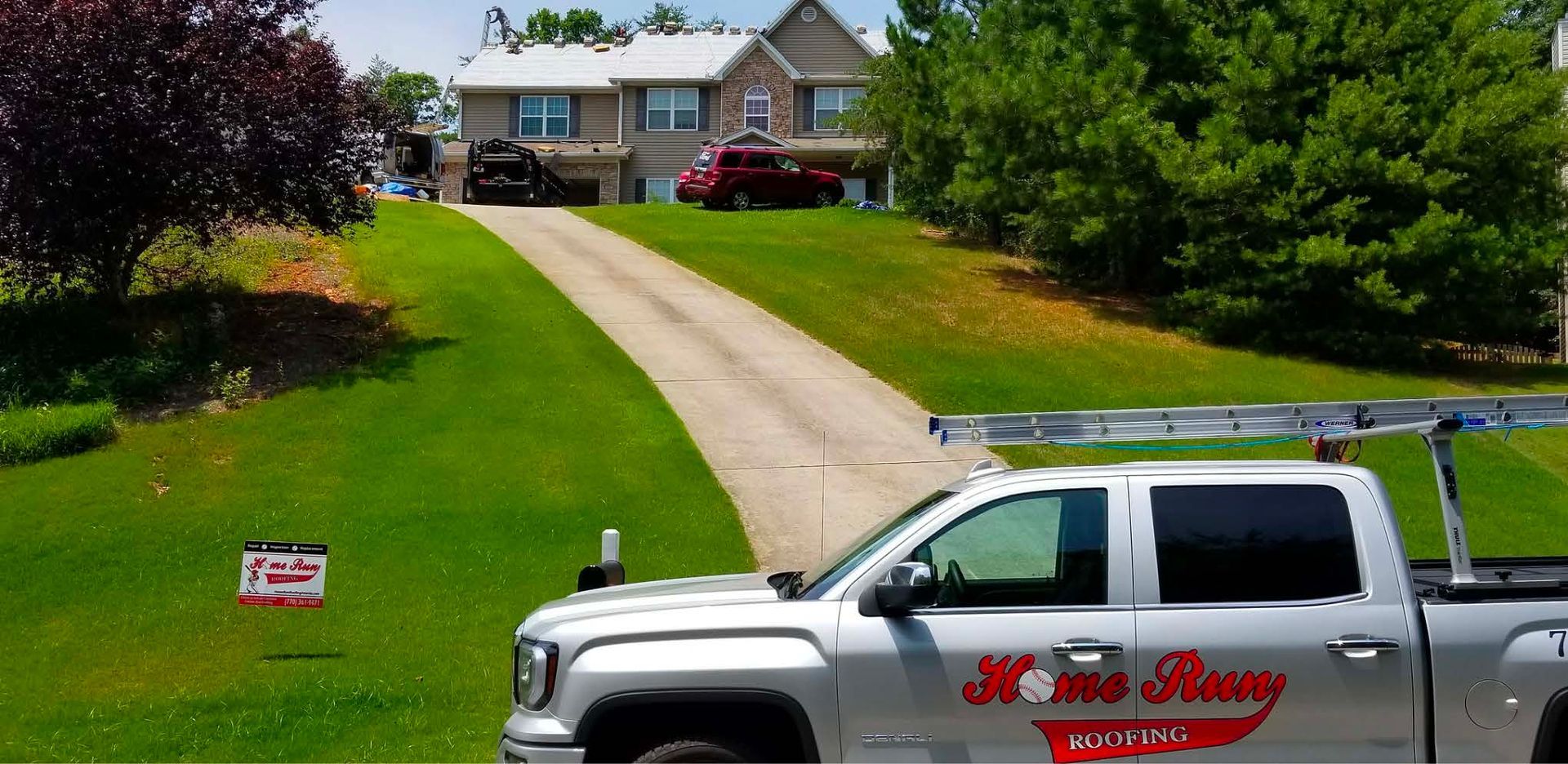 A home warranty truck is parked in front of a house.