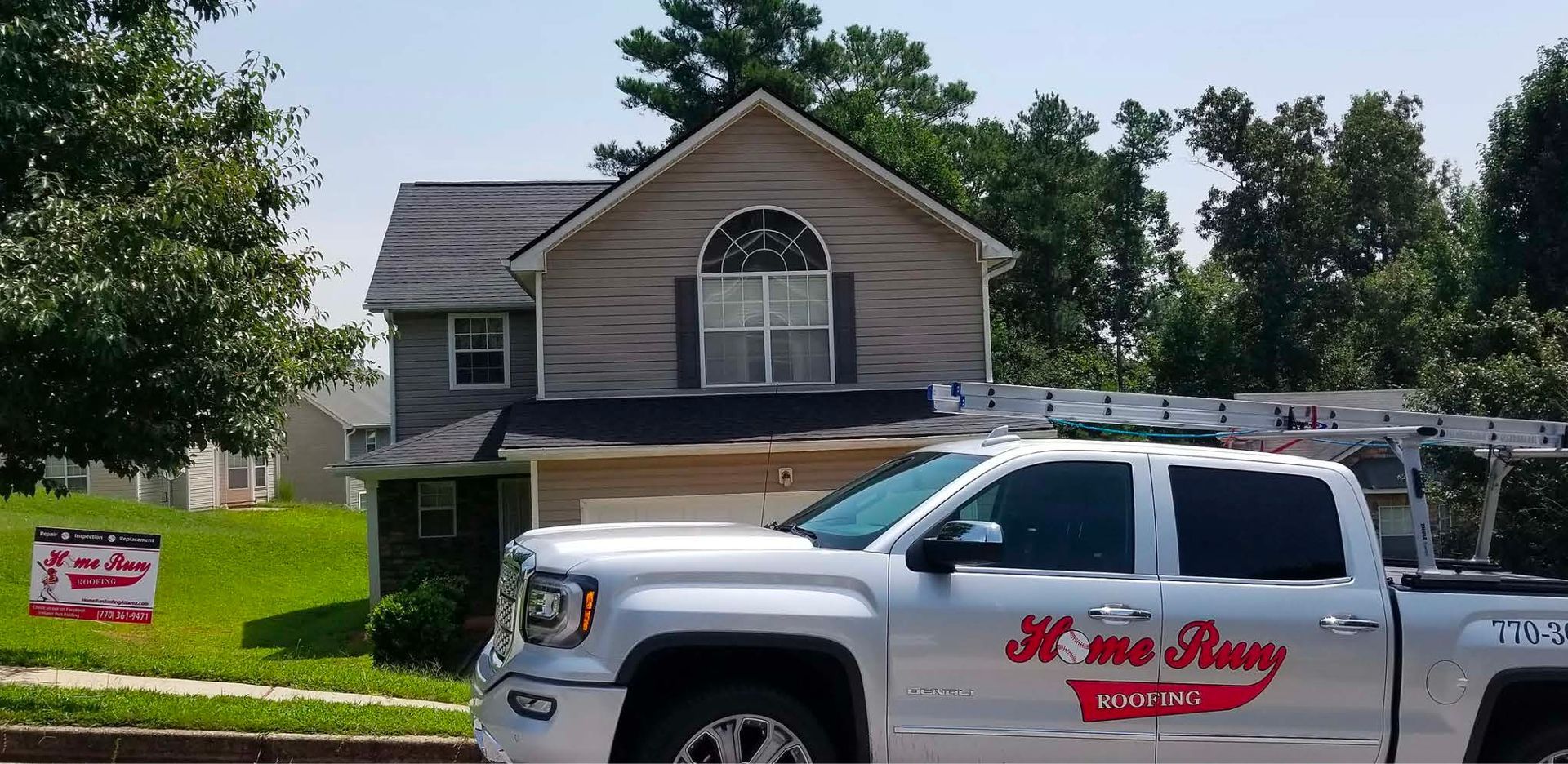 A white truck is parked in front of a house.