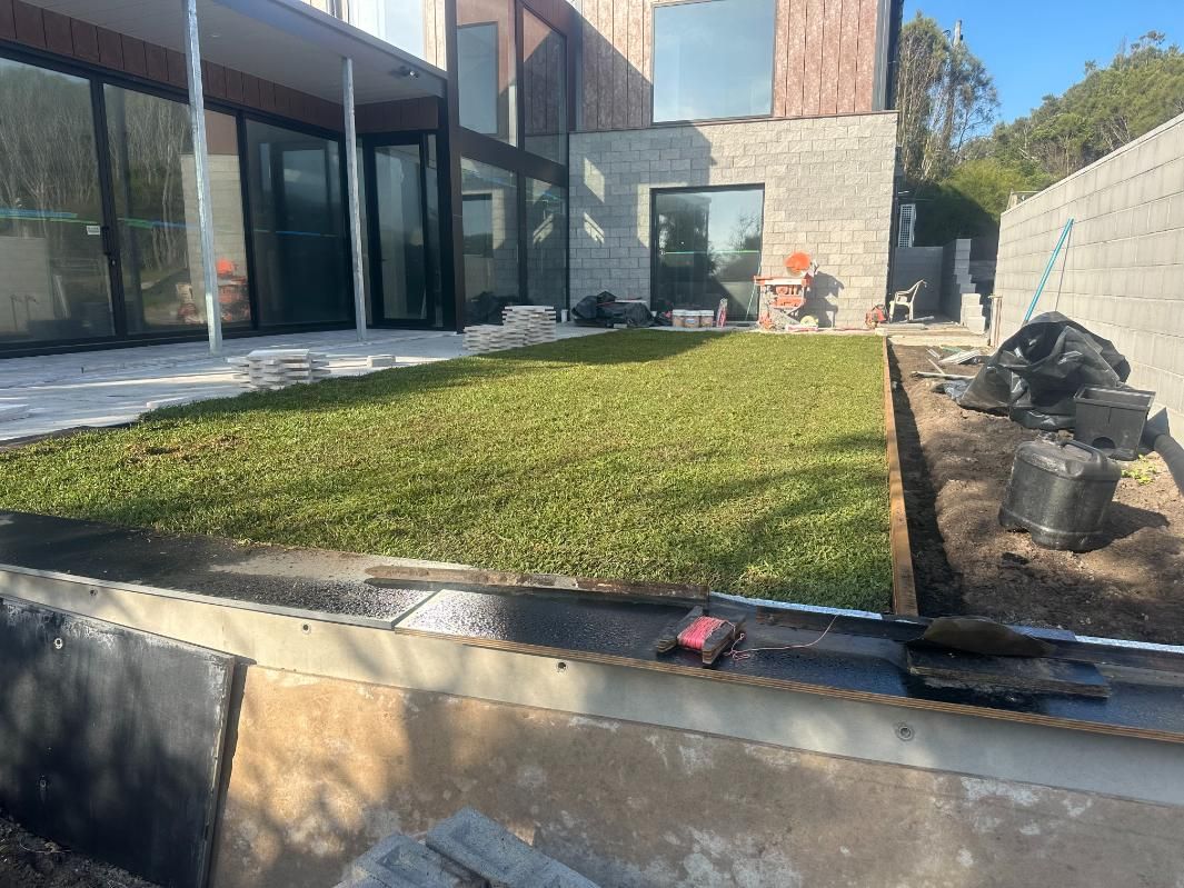 A Large House With A Lush Green Lawn In Front Of It — Southern Turf Supplies In Milton, NSW