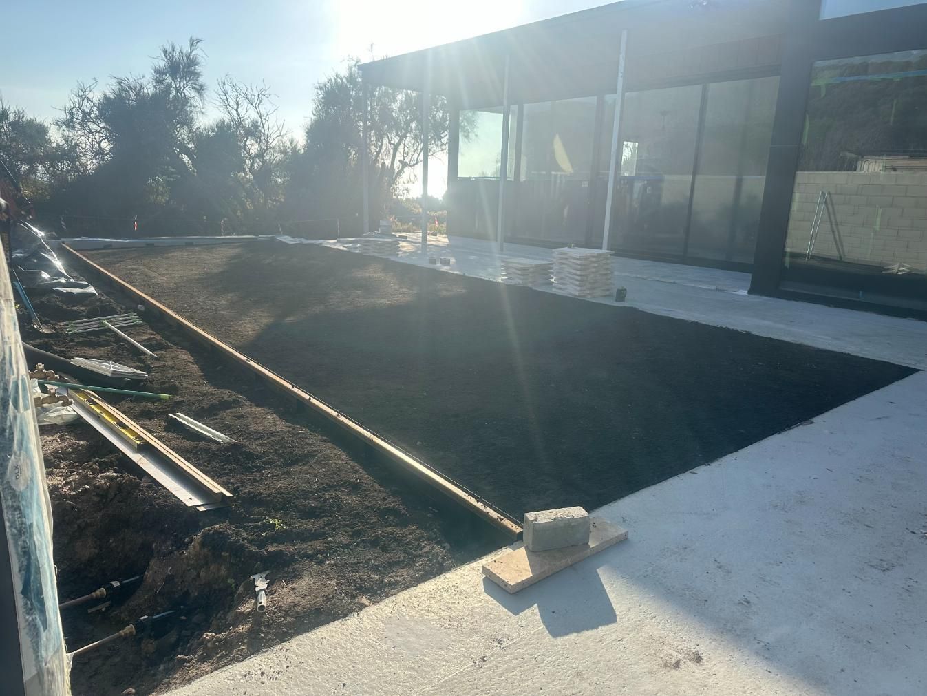 A Concrete Walkway Is Being Built In Front Of A Building — Southern Turf Supplies In Milton, NSW