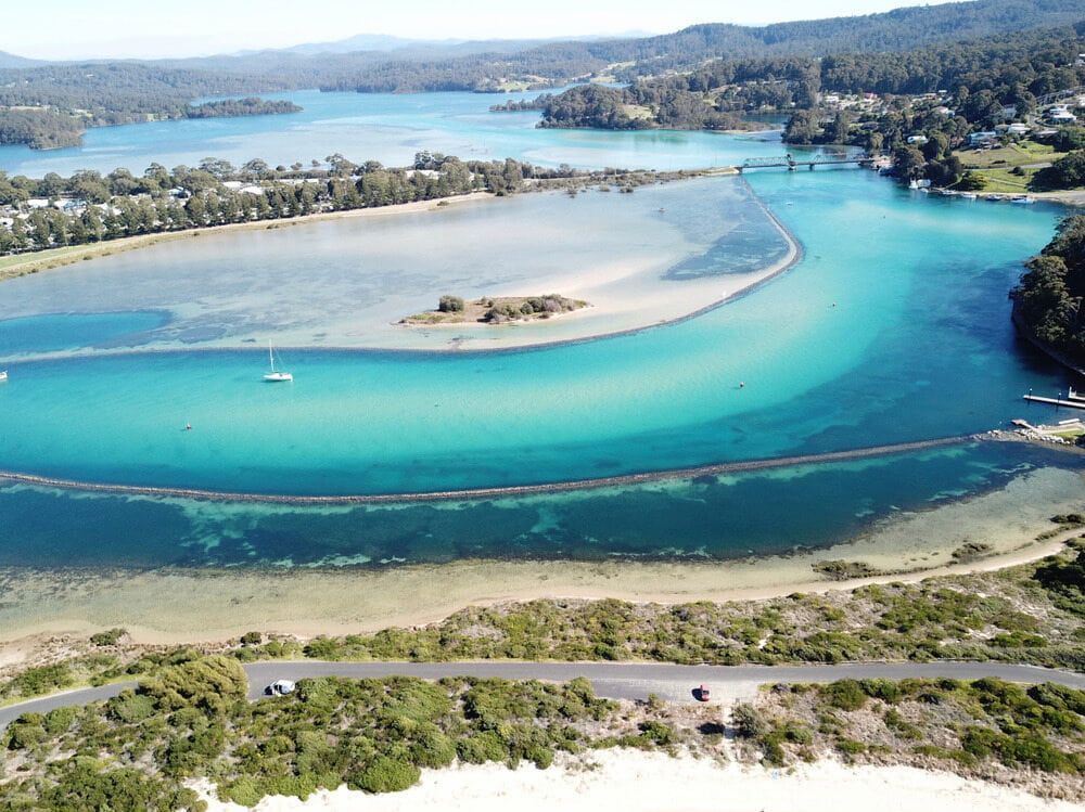 An Aerial View Of A River With A Small Island In The Middle — Southern Turf Supplies In Narooma, NSW