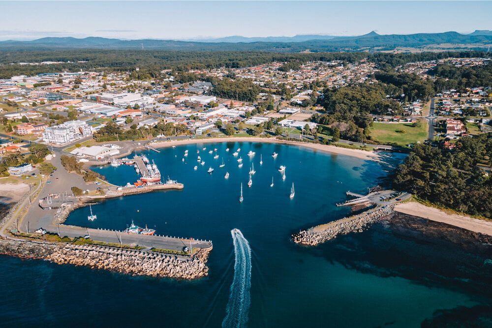 An Aerial View Of A Harbor With Boats In It And A City In The Background — Southern Turf Supplies In Ulladulla, NSW