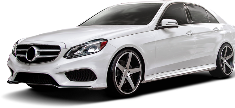A white Mercedes-Benz E-Class sedan with custom multi-spoke wheels, angled from the front side against a white background - Gold River Automotive