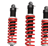 Three shock absorbers with black housings and bright red coils standing side-by-side on a white background - Gold River Automotive