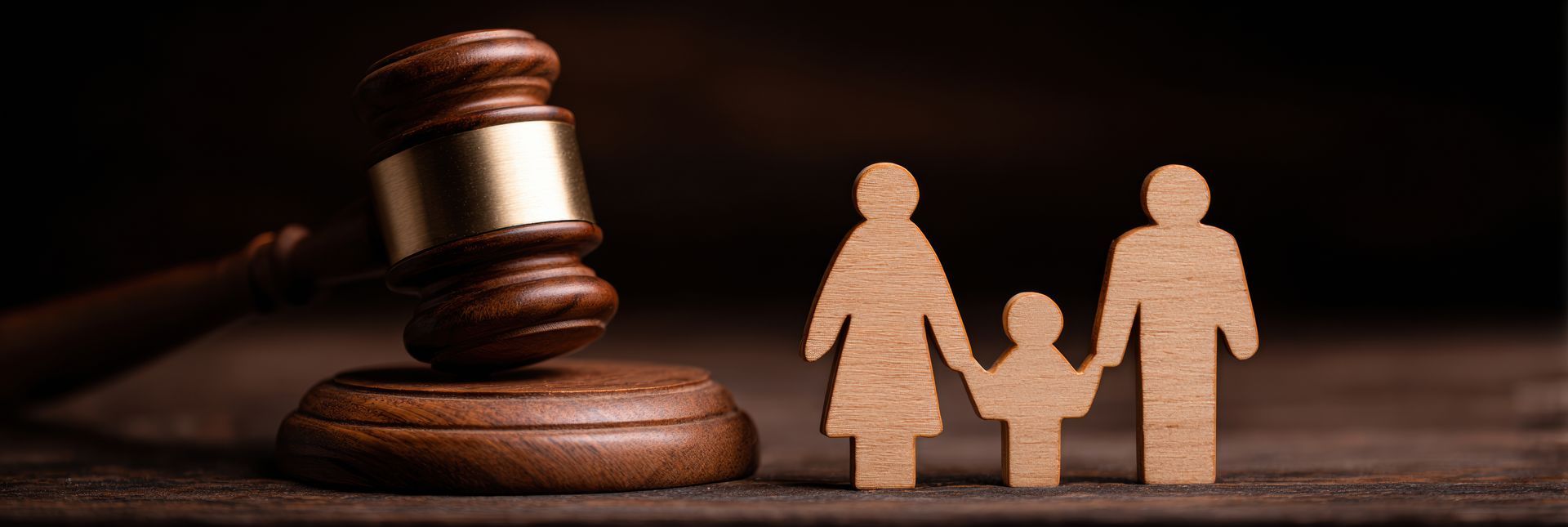 A gavel next to a family cut out. Family law concept.