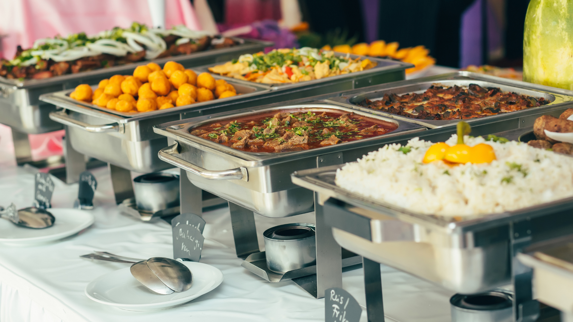 A buffet table filled with lots of different types of food.