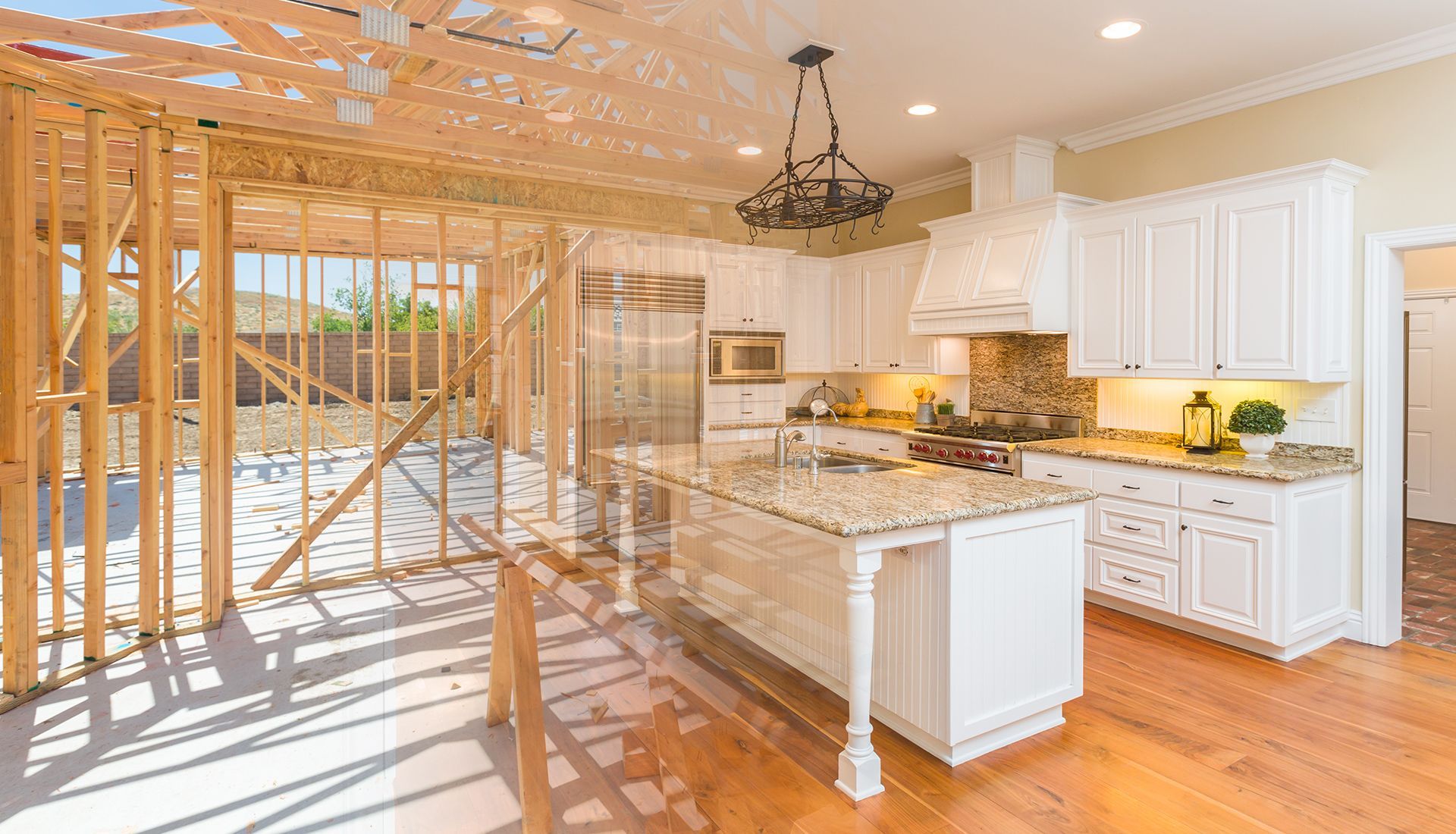 Kitchen under construction, with exposed wooden frame merging into a finished white kitchen with granite countertops.