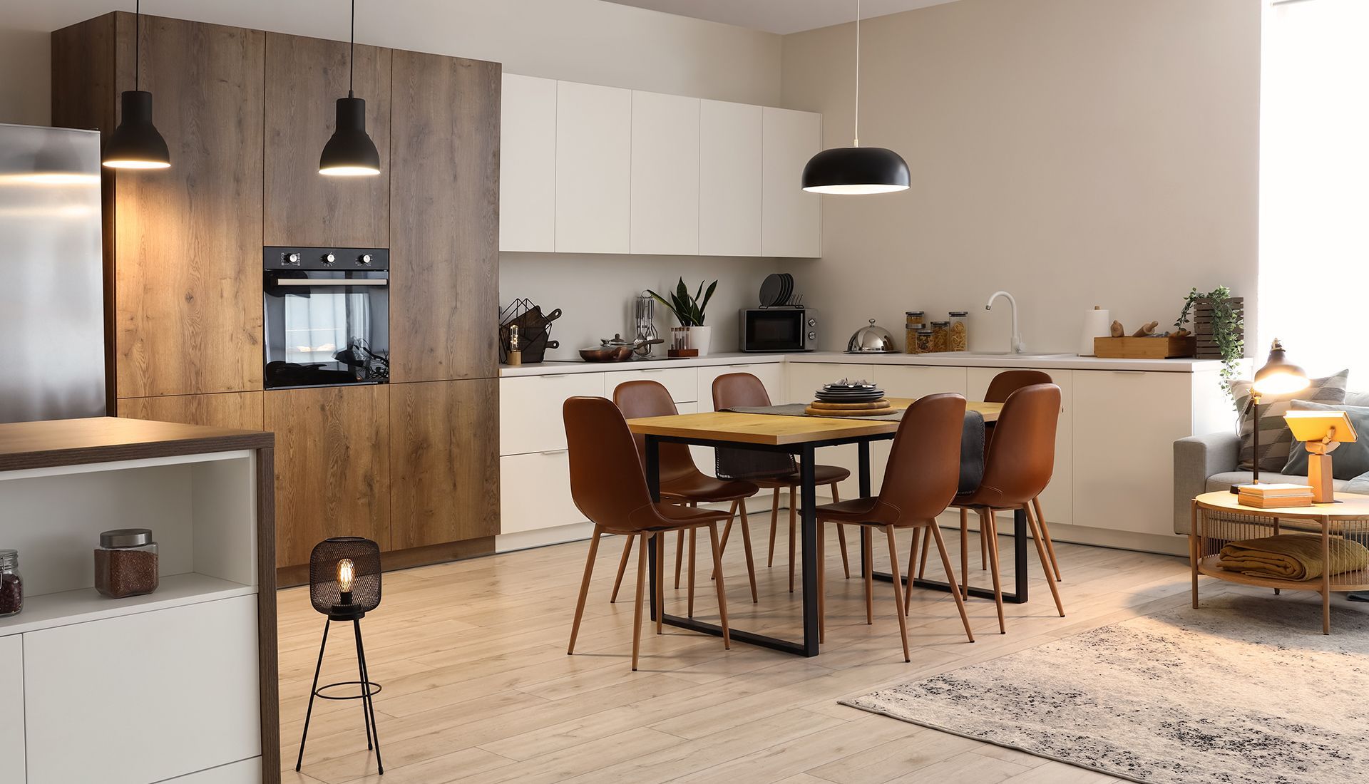Modern kitchen and dining area with wooden cabinets, a table, and chairs.