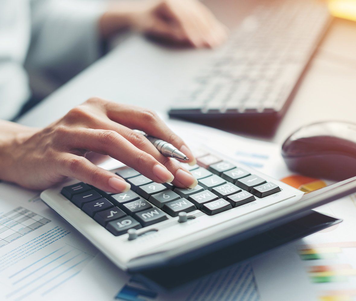 Person Using Calculator — Marianna, FL — LESLIE A. TUCKER, CPA, PA, CERTIFIED PUBLIC ACCOUNTANT