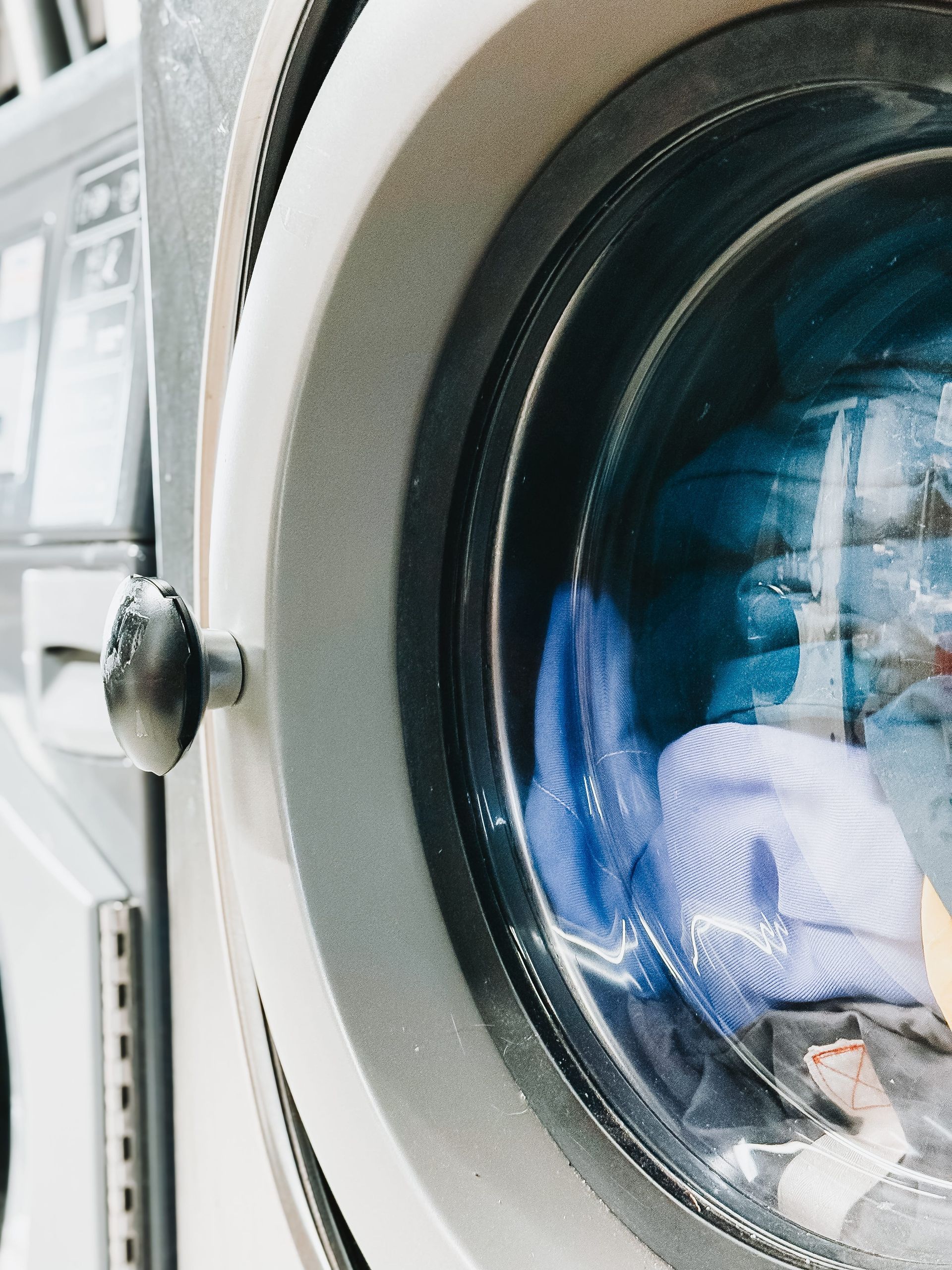 A close up of a washing machine with clothes in it — The Wash House& Laundrette in Dubbo, NSW