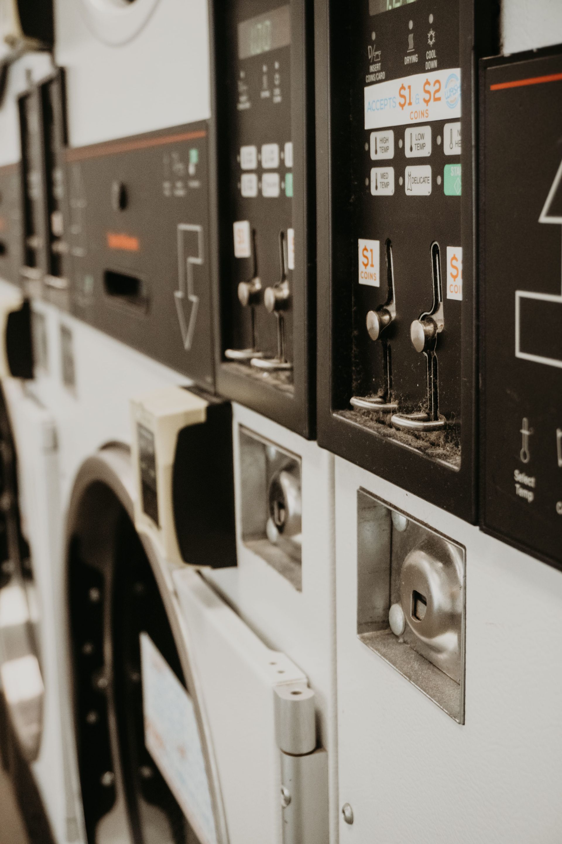 A row of washing machines are lined up in a laundromat — The Wash House& Laundrette in Dubbo, NSW