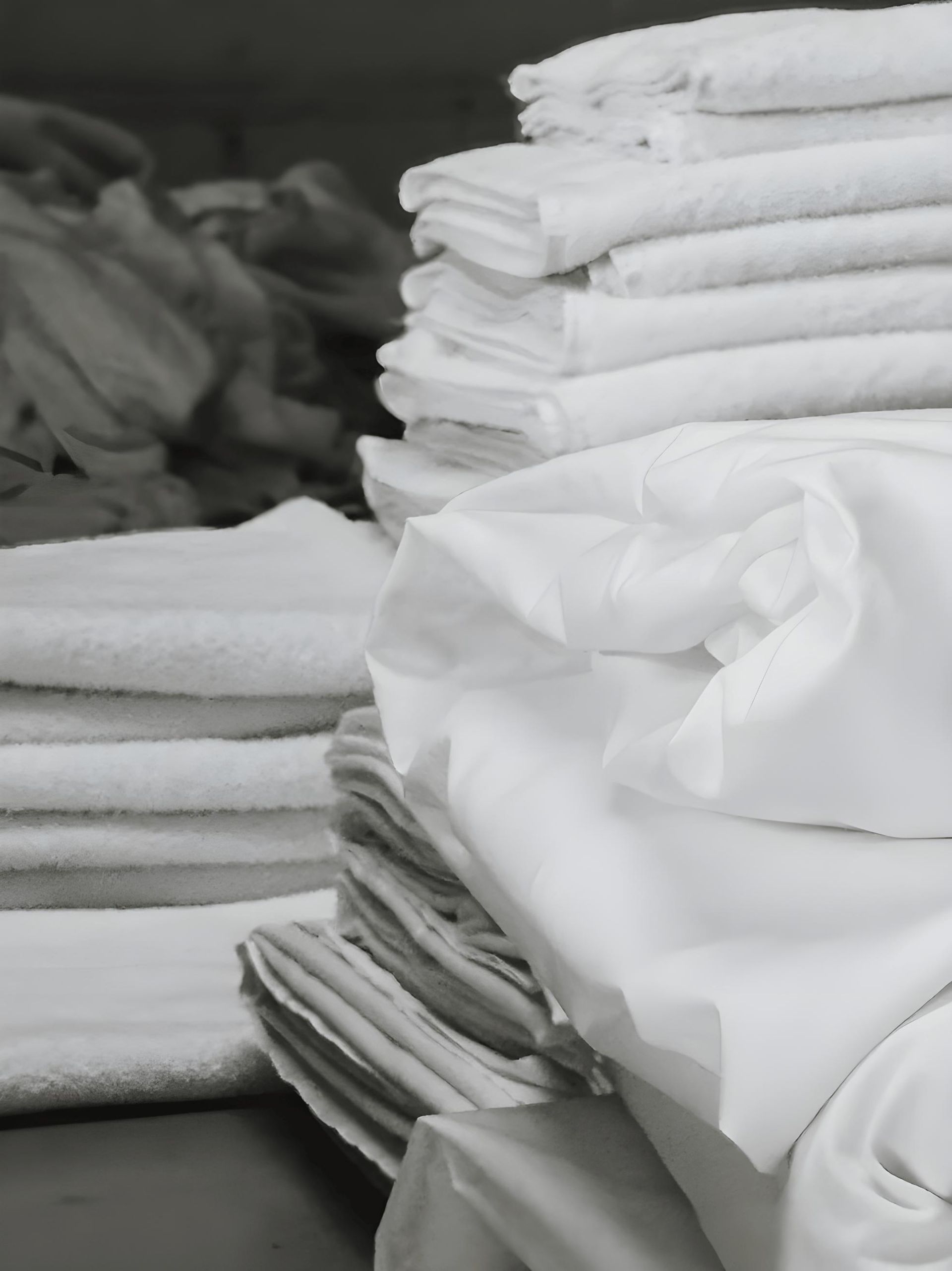 A black and white photo of a pile of white towels — The Wash House& Laundrette in Dubbo, NSW
