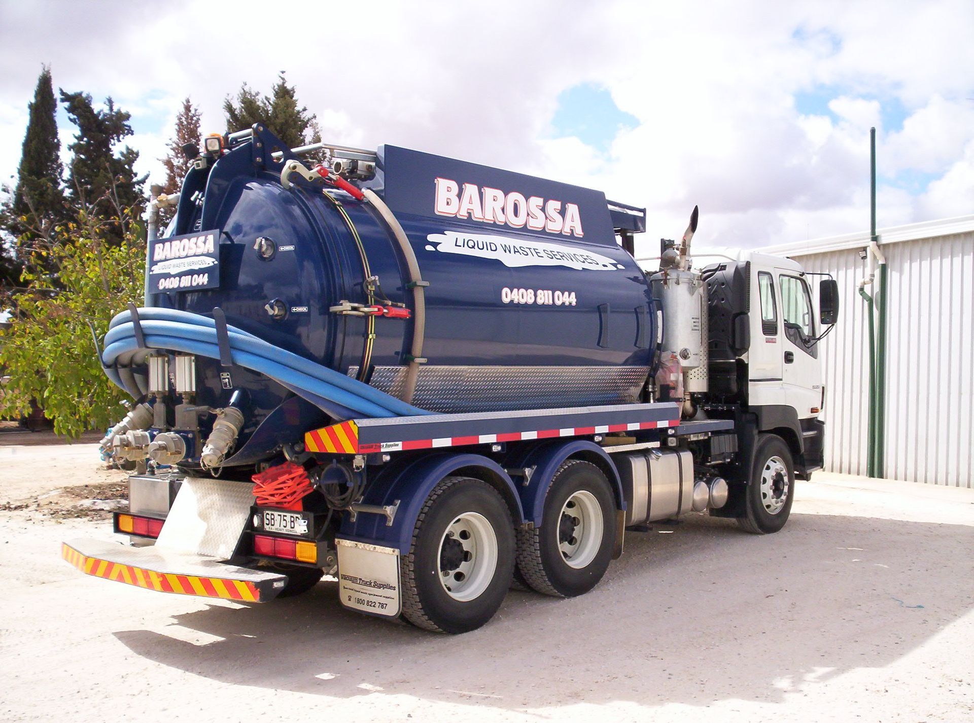 Blue Barossa vacuum truck parked outdoors.