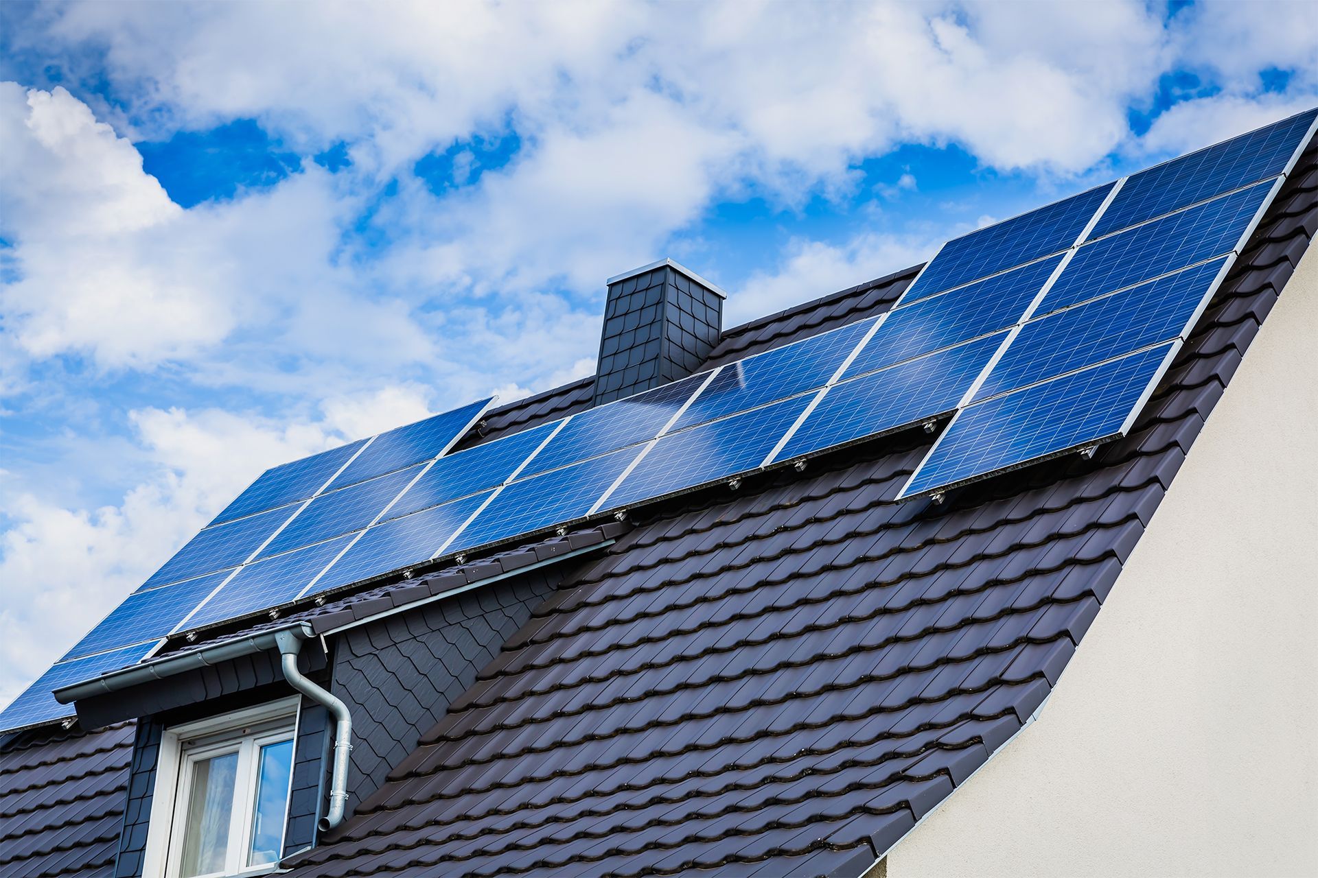 A row of solar panels on the roof of a house
