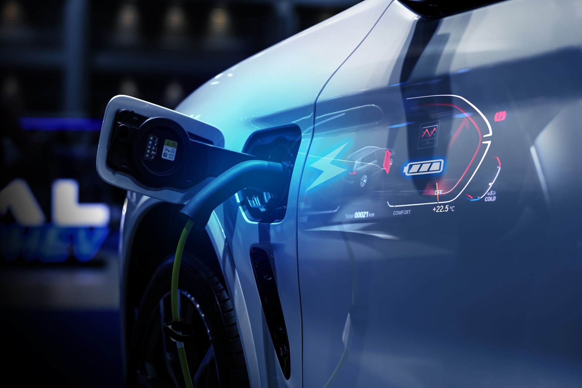 Electric car charging at a station, with a glowing blue plug and digital display in a dark setting