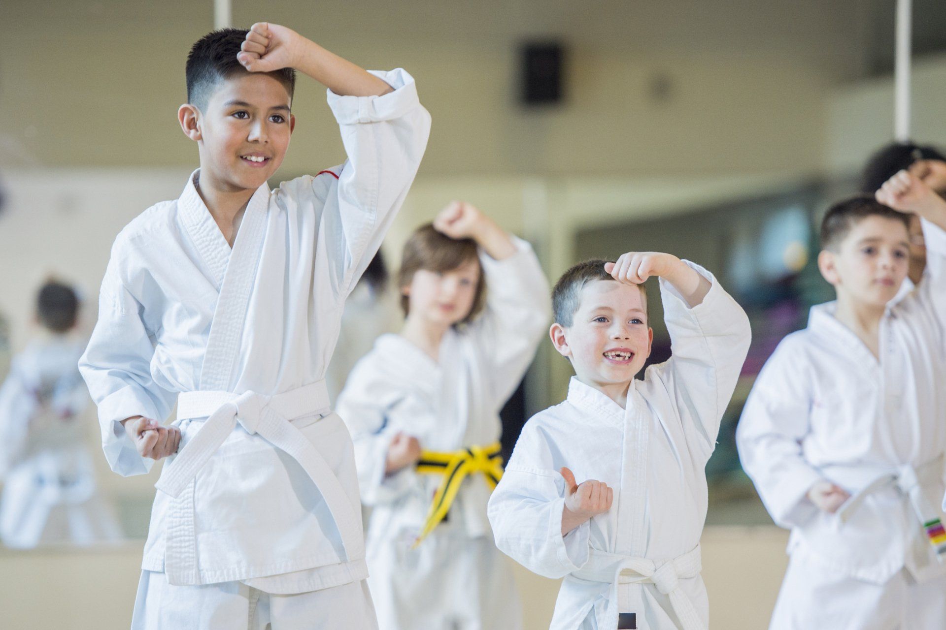 a group of young boys are practicing karate in a gym